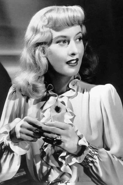 a black and white photo of a woman holding a cell phone