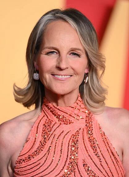 Helen Hunt wearing a short, blonde and brown, flipped-out hairstyle and peach sequins dress