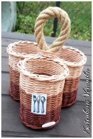 three wicker baskets with forks and spoons in them sitting on a picnic table