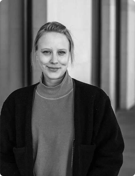Professional black and white portrait of Avery Anderson, exuding a calm and approachable demeanor. Her modern style and confident presence make her a valuable team asset.