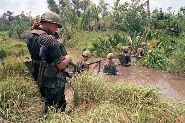U.S. troops of the 7th and 9th divisions wade through marshland during a joint operation on South Vietnam's Mekong Delta, in April of 1967.