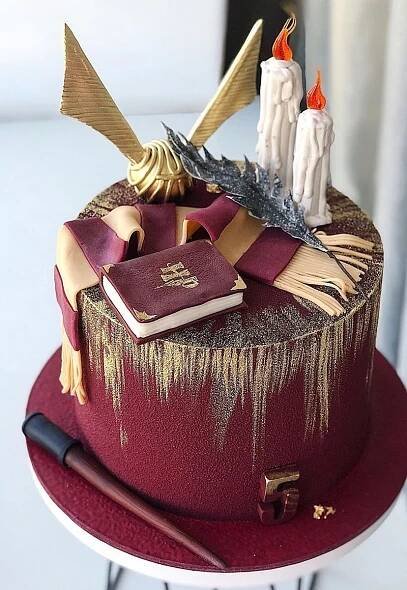 there is a cake with books and other items on it
