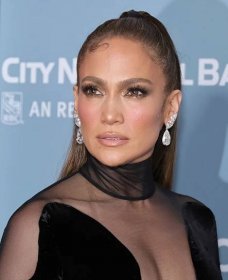 Jennifer Lopez slicked-back updo with baby hair detail, shimmery eye makeup, and pink lip gloss