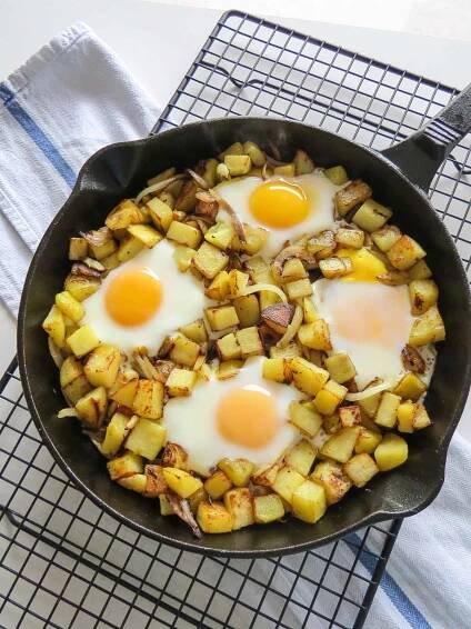 Freshly made skillet hash and eggs cooling on a wire rack.