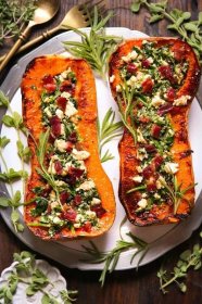 Stuffed Butternut Squash with Feta Cheese, Spinach, and Bacon - on a white plate.