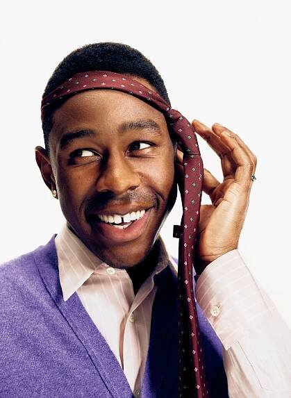 Image may contain Clothing Apparel Tyler The Creator Face Human Person Smile Tie Accessories and Accessory