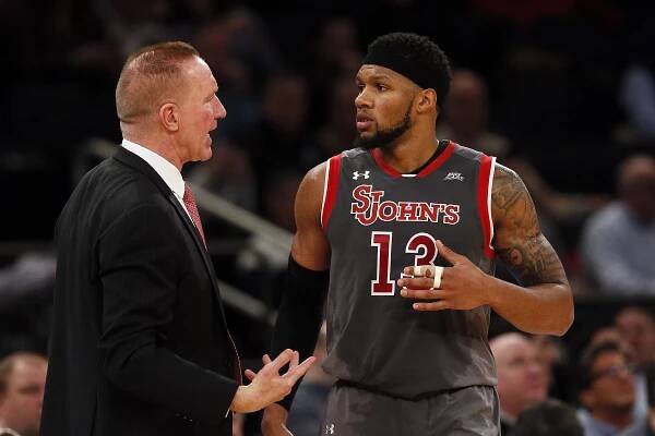 St. John's coach Chris Mullin speaks with Marvin Clark II.