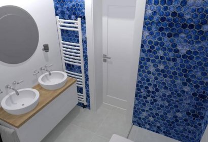 Dveře do koupelny - po pravé straně je sprchový kout a nalevo jsou dvě umyvadla.