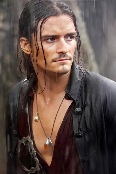 a man with long hair wearing a leather jacket and necklaces in the rain,