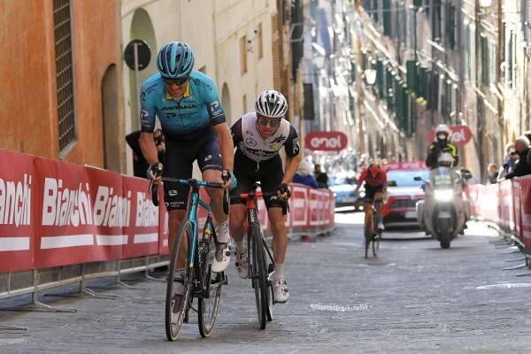 SIENA ITALY  MARCH 06 Jakob Fuglsang of Denmark and Team Astana  Premier Tech  Simon Clarke of Australia and Team Qhubeka Assos during the Eroica  15th Strade Bianche 2021 Mens Elite a 184km race from Siena to Siena  Piazza del Campo  StradeBianche  on March 06 2021 in Siena Italy Photo by Luc ClaessenGetty Images
