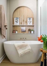 bathroom with tub and shelves