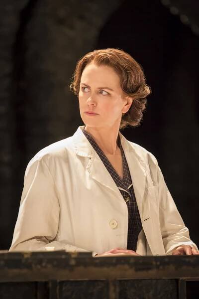 actor on stage dressed in a lab coat
