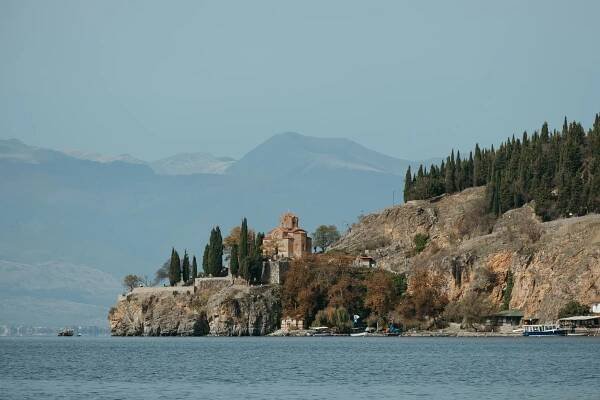 A small church perches on the edge of a cliff over Lake Ohrid.