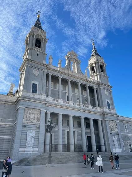 Madrid cathedral from the front with blue skies above.