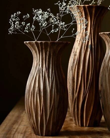 three vases sitting on top of a wooden table