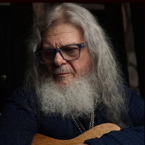 Oscar/Grammy winner Gustavo Santaolalla poses for a portrait in his studio with a acoustic guitar on Friday, Oct. 18, 2024.