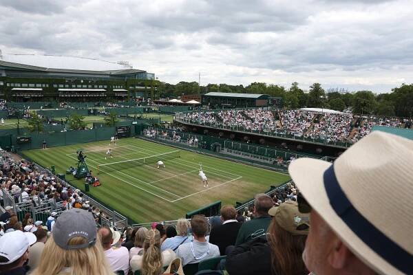 Spectators watching a tennis match at Wimbledon.