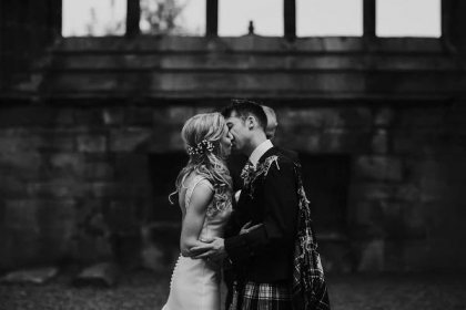 first kiss at their melrose abbey wedding ceremony