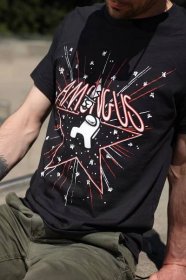 A close up torso photograph of a model wearing a black Among Us: 5th Anniversary Tee designed by Amy Liu. The Tee depicts a white Impostor among a flurry of stars and fireworks. The impostor stands in the middle of a red outlined star holding a bloody knife over their head. “Among Us” text is written in red and white sitting on top of the outlined star.