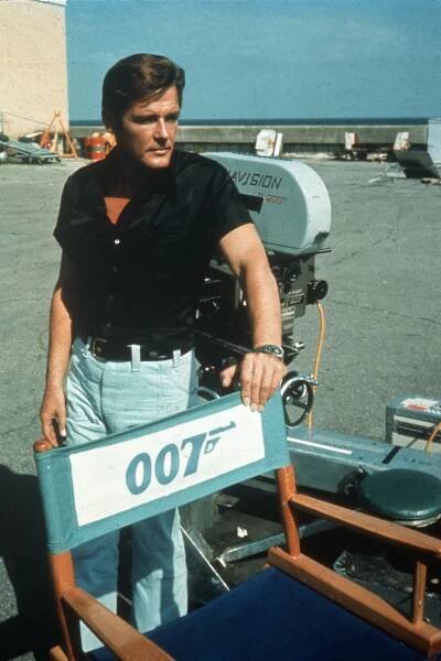 ROGER MOORE, THE ELEGANT BOND – Portrayed Bond in: 'Live and Let Die,' 'The Man with the Golden Gun,' 'The Spy Who Loved Me,' 'Moonraker,' 'For Your Eyes Only,' 'Octopussy,' and 'A View to a Kill.' Roger Moore had the best possible endorsement when stepping into the role of James Bond: the blessing of his predecessor, Sean Connery — despite the fact that his version of the agent was a complete departure from the one Connery had embodied. The two couldn’t have been more different. Where Connery brought intensity and old-school masculinity, Moore delivered sophistication and wit. Connery was a scrappy Irishman; Moore was the embodiment of British charm. After the fiasco of George Lazenby, producers didn’t take a chance on another unknown. Instead, they went with a proven television star. Moore was already widely known as 'The Saint' — Simon Templar — before donning the tuxedo. He became the most elegant Bond, and also the oldest. He joined the franchise at 45. Knowing he had to set himself apart from his predecessor, Moore introduced subtle distinctions: he smoked cigars instead of cigarettes and never drove the iconic Aston Martin. He wasn’t a man of action — in fact, he looked so awkward running that a stunt double had to be used for chase scenes. But no one ever held a glass of Bollinger with more class. Moore bowed out when he felt he was too old to convincingly woo the ever-youthful Bond girls — a staple of the franchise. “The leading ladies were young enough to be my granddaughter,” he remarked. Elegant, on screen and off. 
