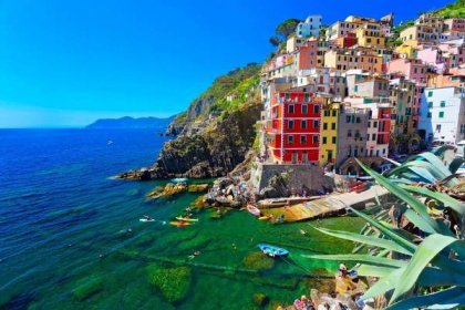 View of colourful Riomaggiore with plants in foreground