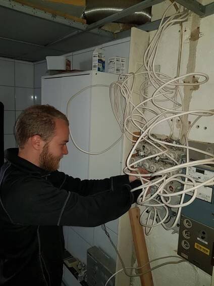 Elektriker demonterar gammal elcentral.
