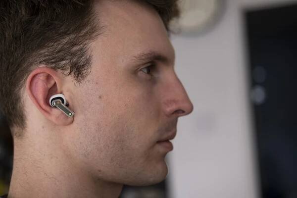 Man wearing Nothing Ear 2 earbuds.