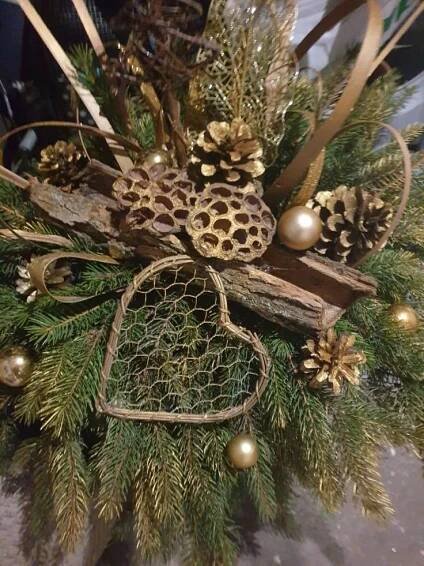 an arrangement of pine cones and other holiday decorations