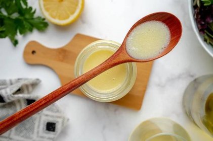 wooden spoon with lemon beurre blanc in the well 
