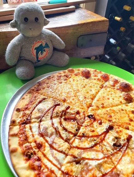 Buddy enjoying his pizza at The Brown Jug