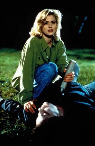 Kristy Swanson on a football field driving a stake in a still from 'Buffy the Vampire Slayer'
