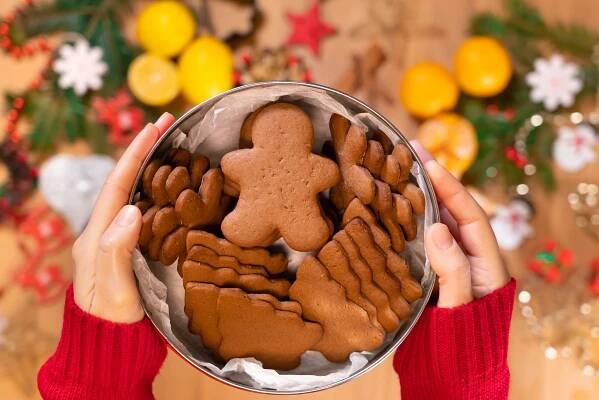 woman holding a box of gingerbread cookies