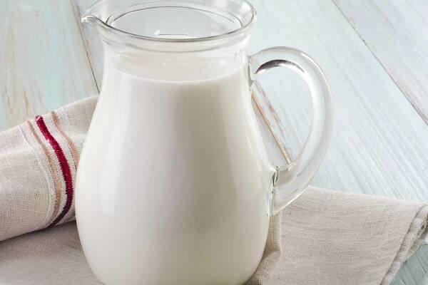 Heavy cream in glass pitcher.