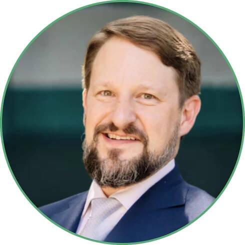 A man with a beard is smiling in a circle
