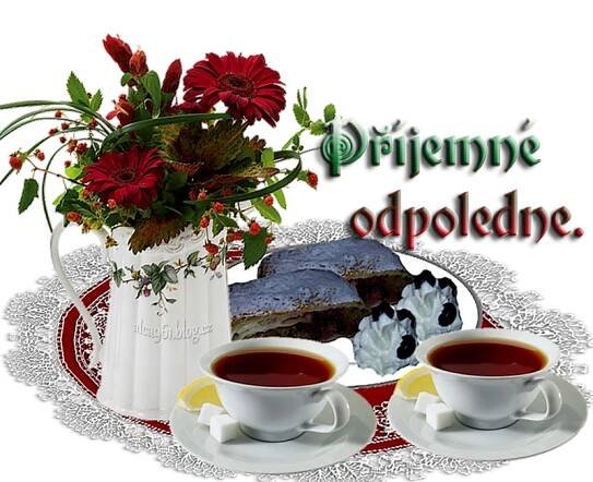 there are two cups of tea on the table with flowers and cake in the background