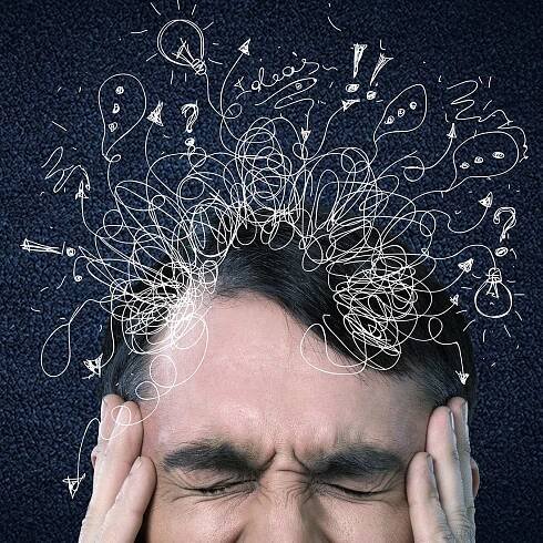 Man with distracting thoughts bursting out of his head.