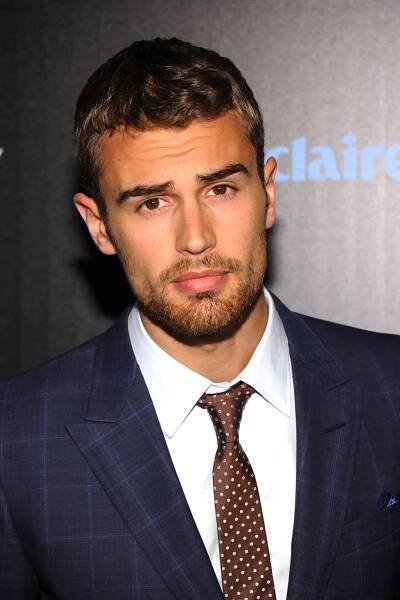 a man in a suit and tie looking at the camera with a serious look on his face