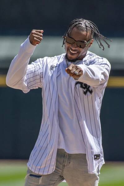 Chicago Bears safety Jonathan Owens throwing the first pitch at a baseball game between the Chicago White Sox and Cincinnati Reds