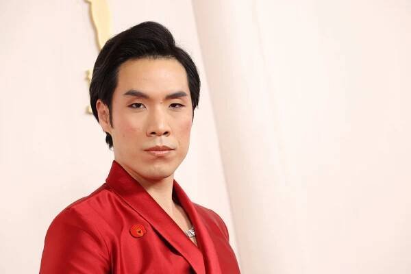 Eugene Lee Yang wearing an Artists For Ceasefire pin.