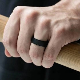 hand wearing a breathable matte black silicone wedding band ring