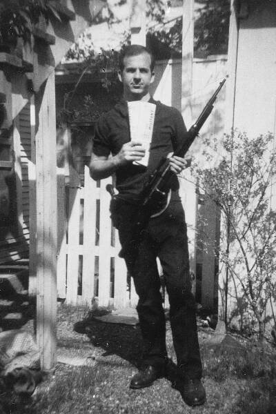 Lee Harvey Oswald posing with rifle, taken in Oswald's back yard, Neely Street, Dallas Texas, March 1963.