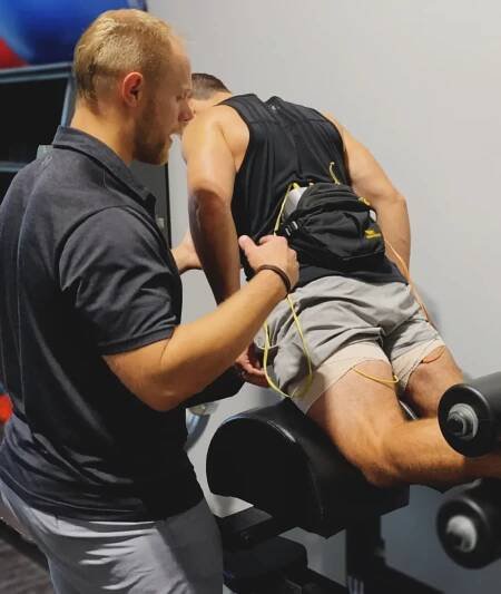 Tyler coaches on nordic hamstring