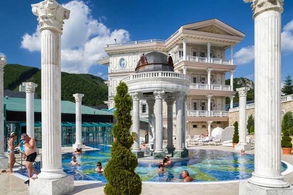 People swimming in an outdoor pool at Aprohrodite Spa in Rajecké Teplice, Slovakia