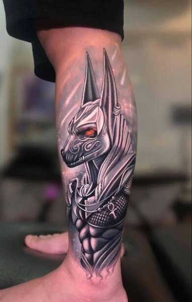 a man's leg with a dragon tattoo on it