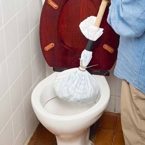 unblocking a toilet
