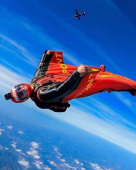 Wingsuit flyer in mid-air.