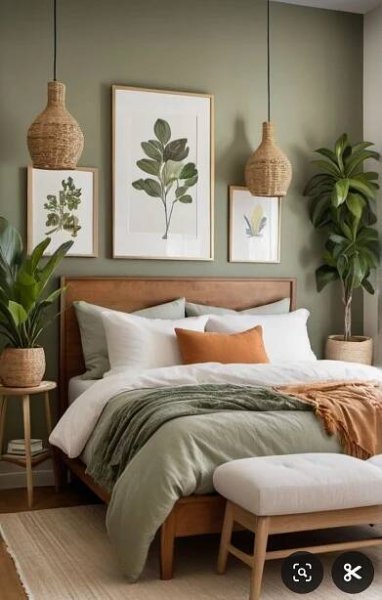 a bed sitting in a bedroom next to two potted plants