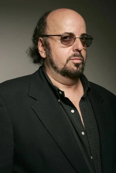 A portrait of James Toback dressed all in black.