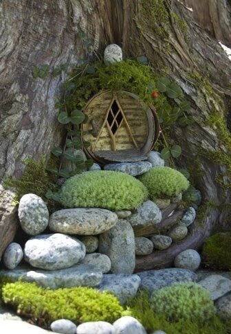 a tree with rocks and moss growing on it's sides, in the shape of a hobbot