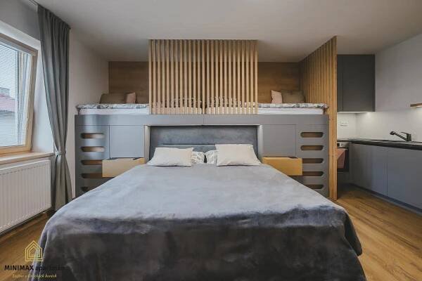 a bedroom with a large bed in a room at MINIMAX apartmán in Deštné v Orlických horách